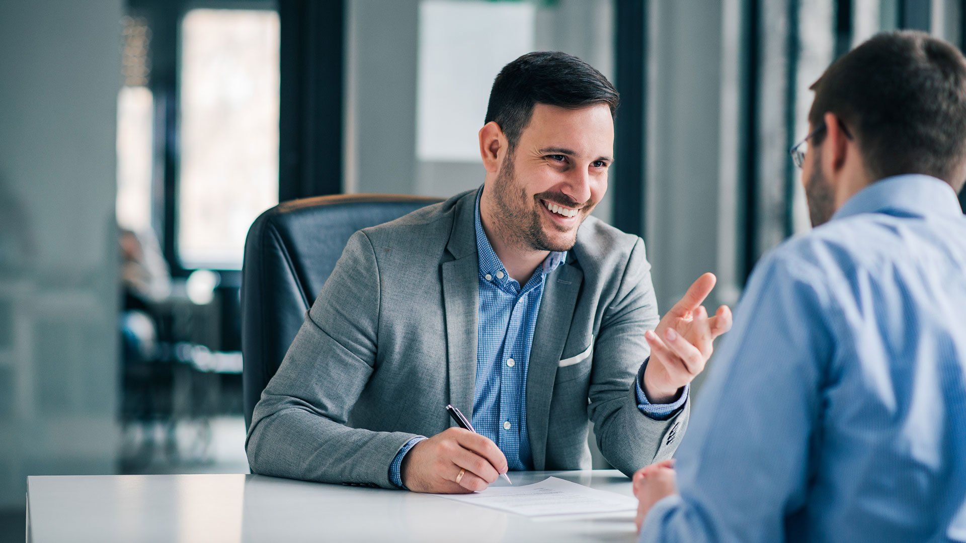 Smiling Man with Lawyer — Oakland, CA — Law Offices of Mark E Rubke