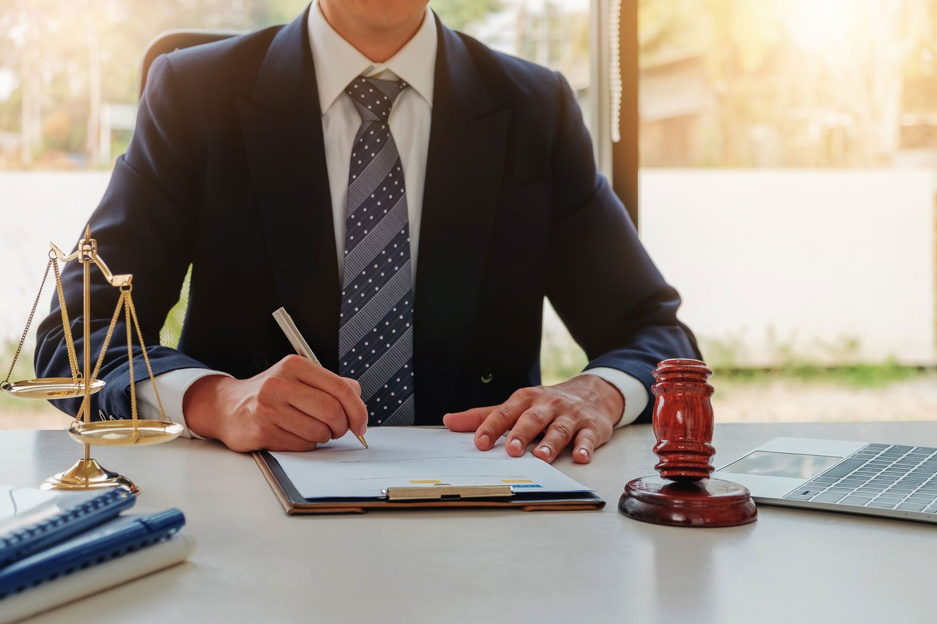 Male Lawyer Writing on A Paper — Oakland, CA — Law Offices of Mark E Rubke