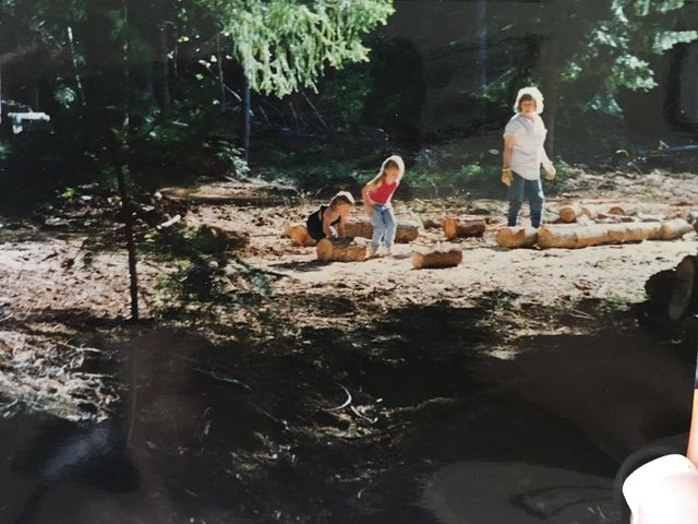 Kids clearing logs away form their property