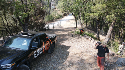 men working on defensible space for egress roads