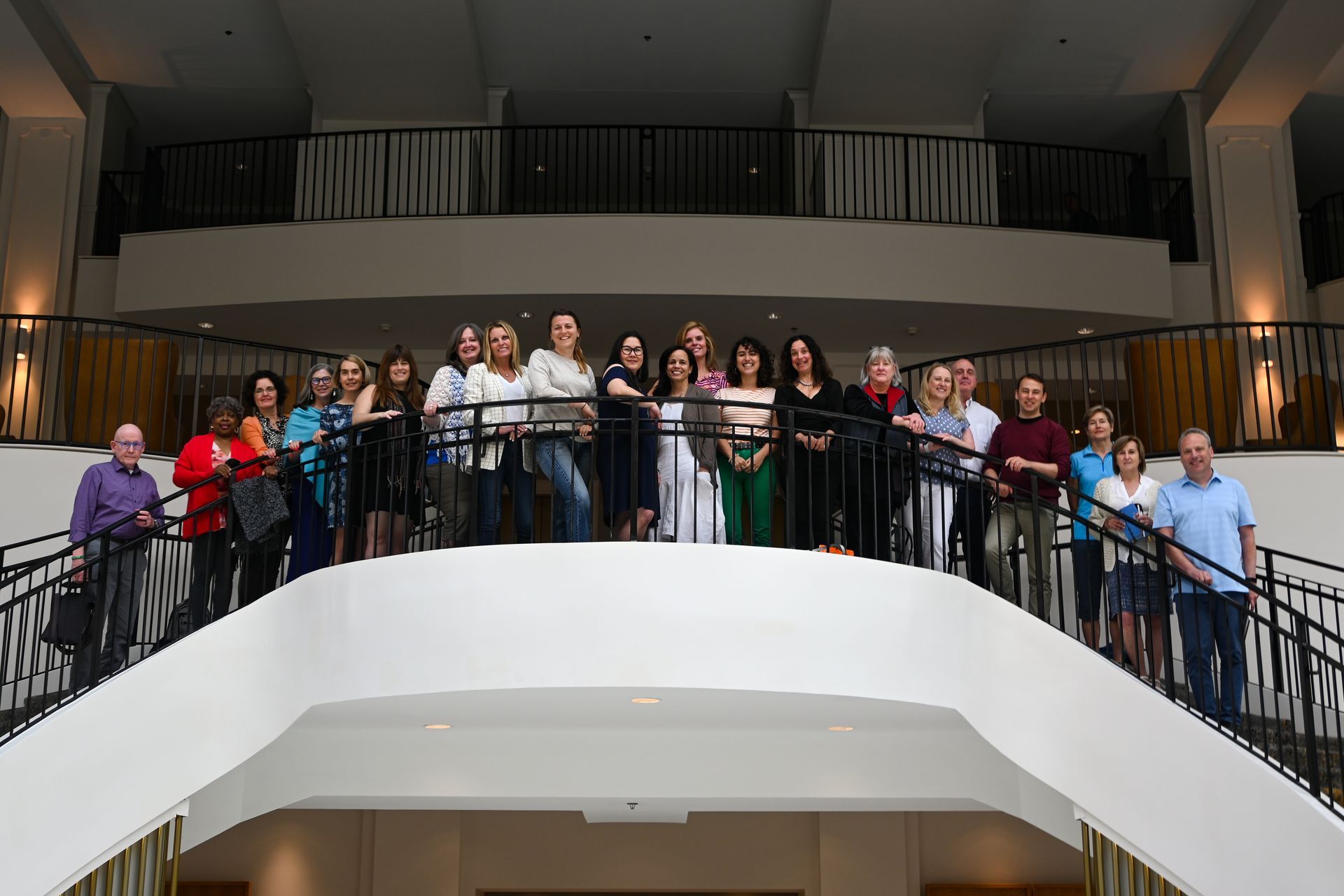 A group of people are posing for a picture on a balcony.