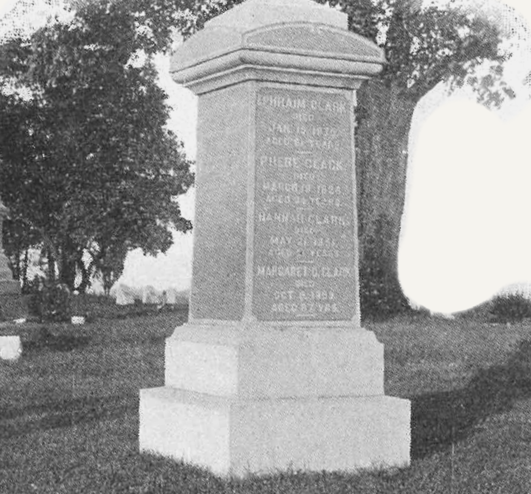 A black and white photo of a monument in a cemetery