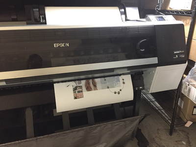 Large Epson inkjet printer printing a wide format document.