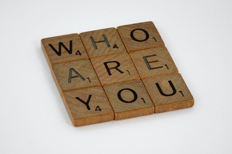 Wooden scrabble tiles that say who are you