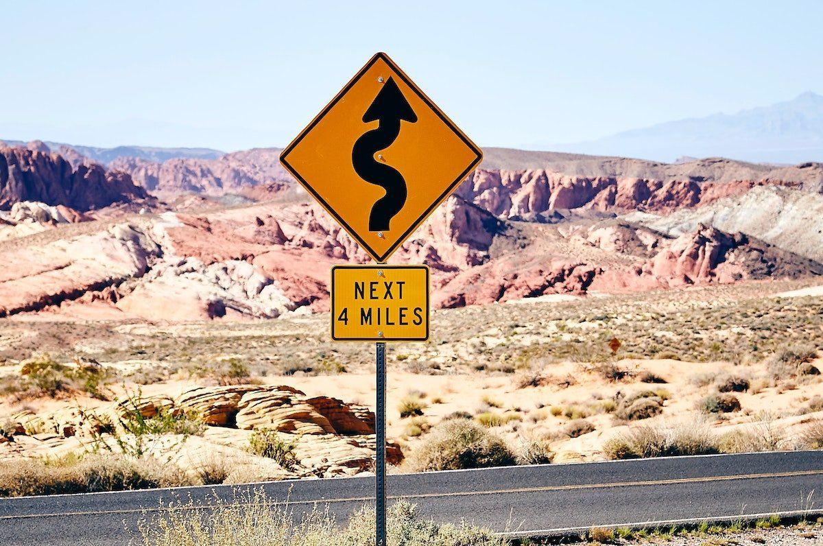 A road sign that says next 4 miles on it