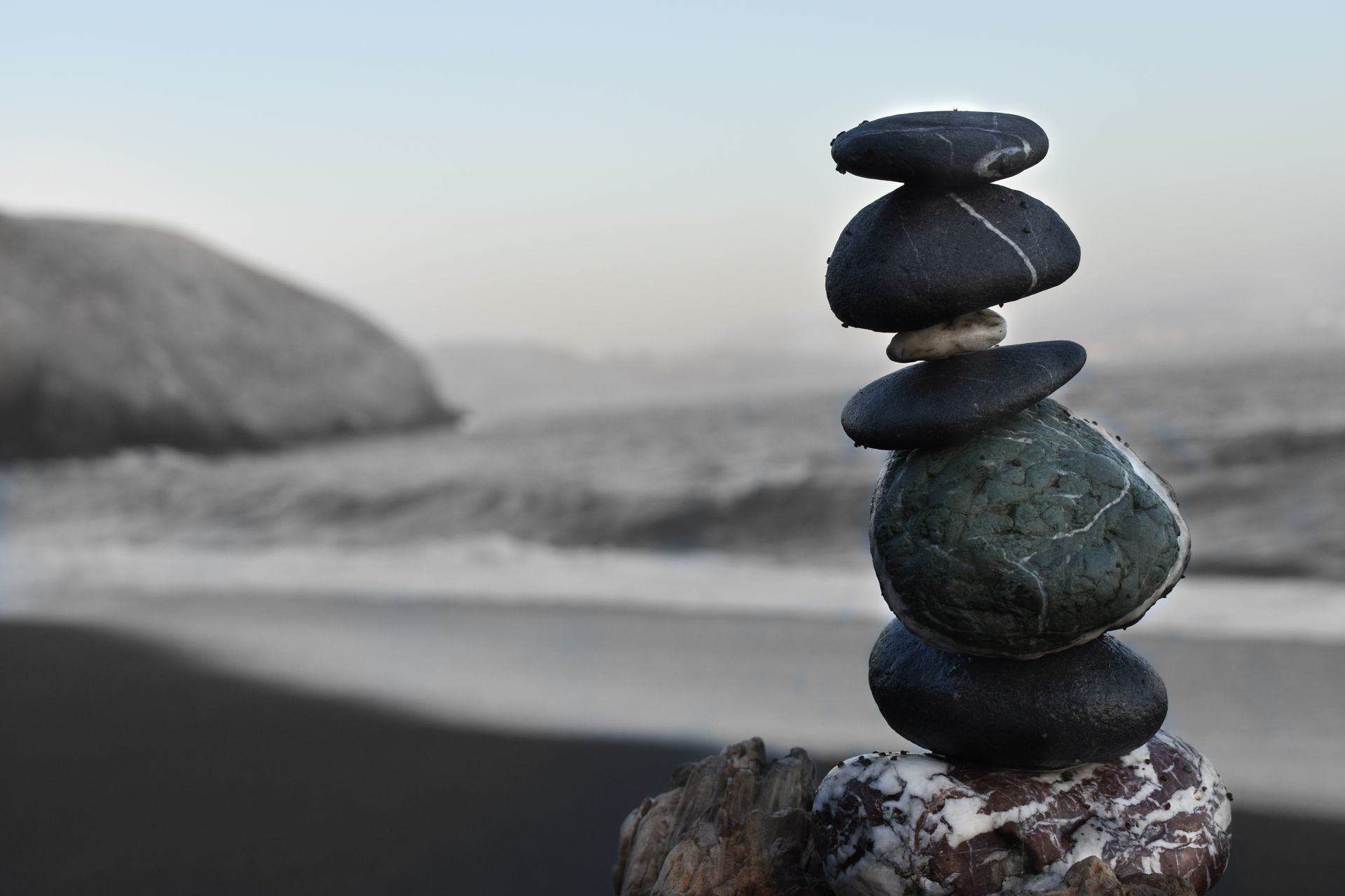 A pile of rocks stacked on top of each other on a beach.
