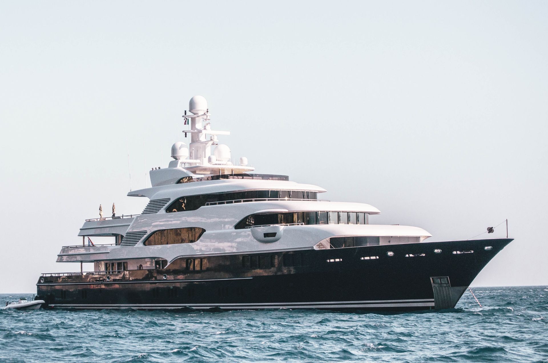 A large yacht is floating on top of a body of water.