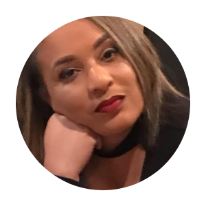 Portrait of a person resting their chin on their hand, with red lipstick and a neutral expression
