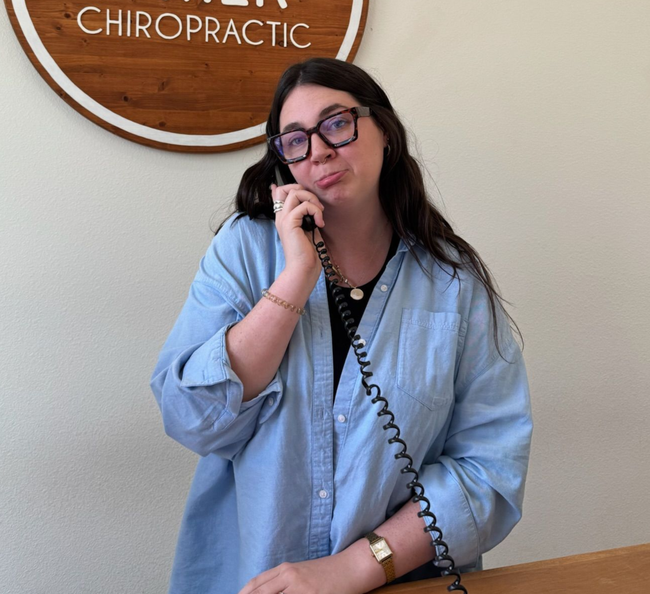 One woman on the phone behind the front desk at Living Water Chiropractic.