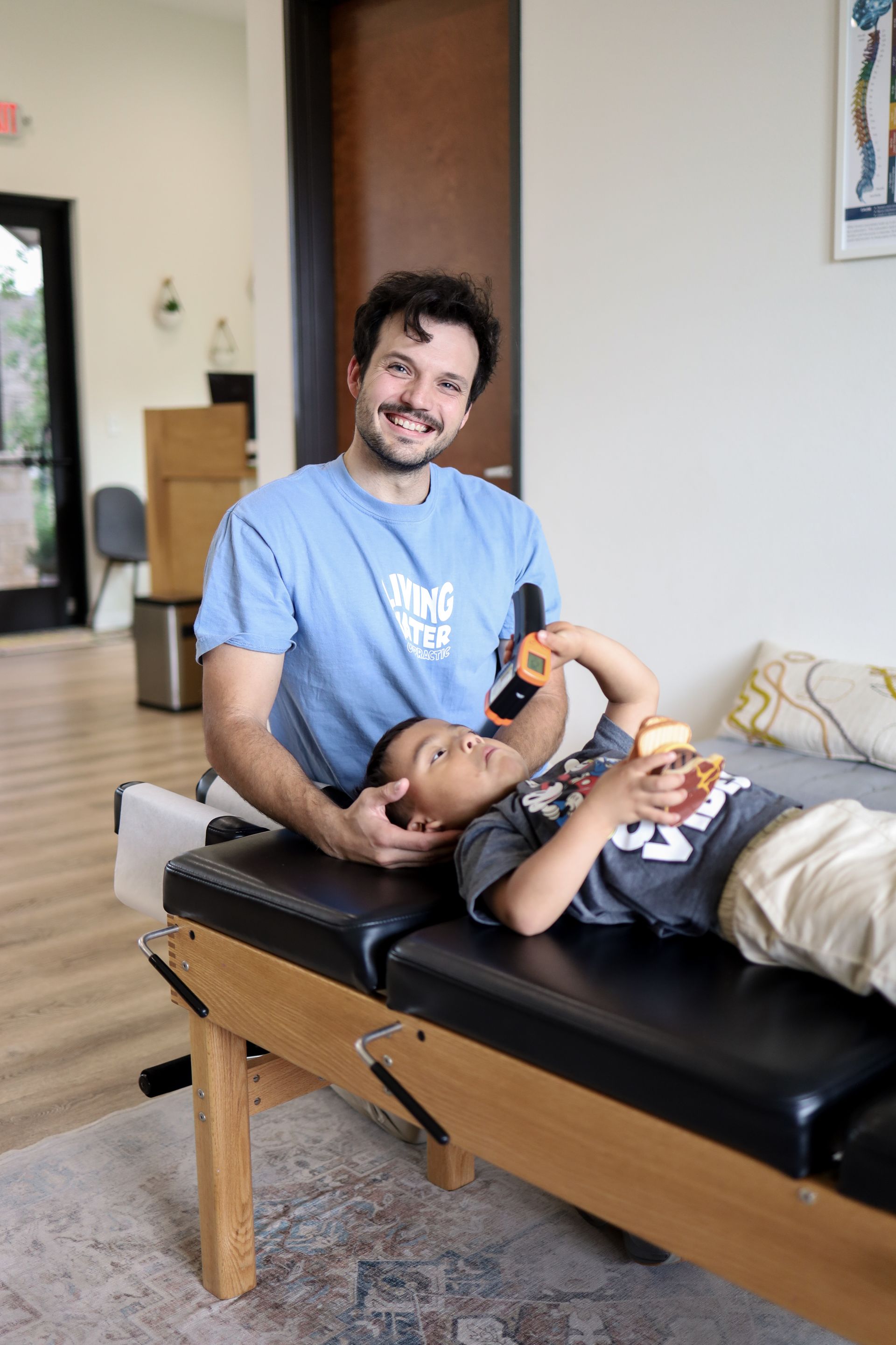 Chiropractor adjusting a pediatric patient.