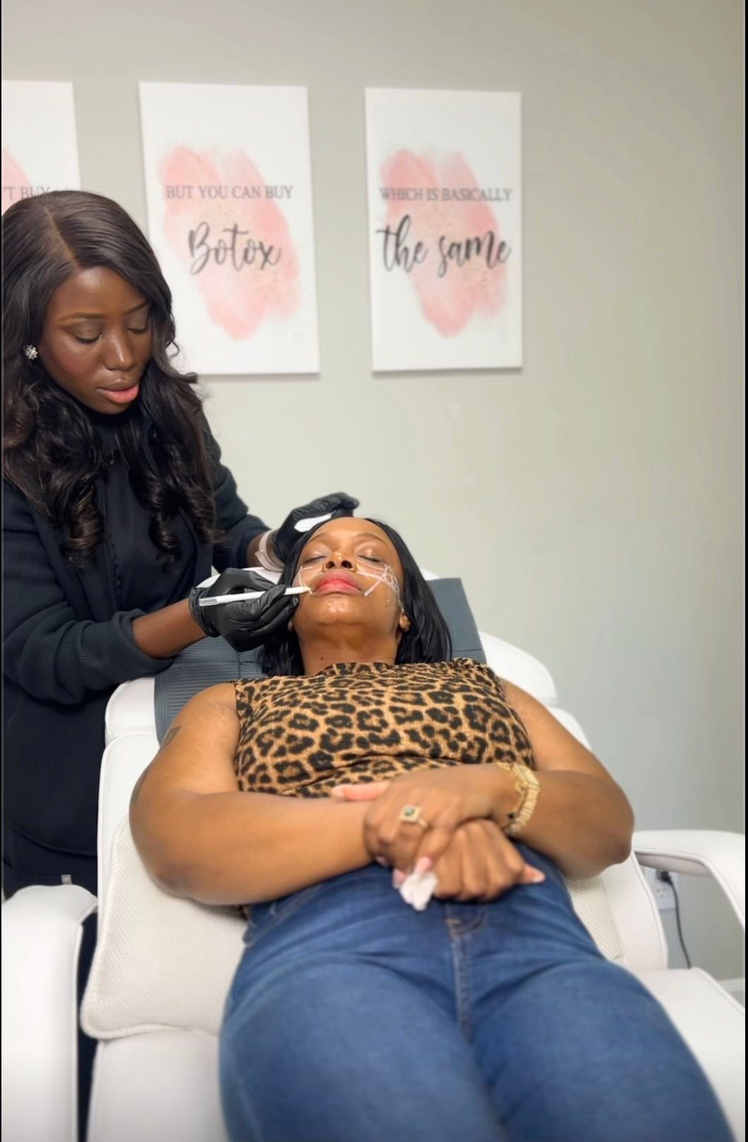 A woman receives a facial treatment while reclining in a salon chair.