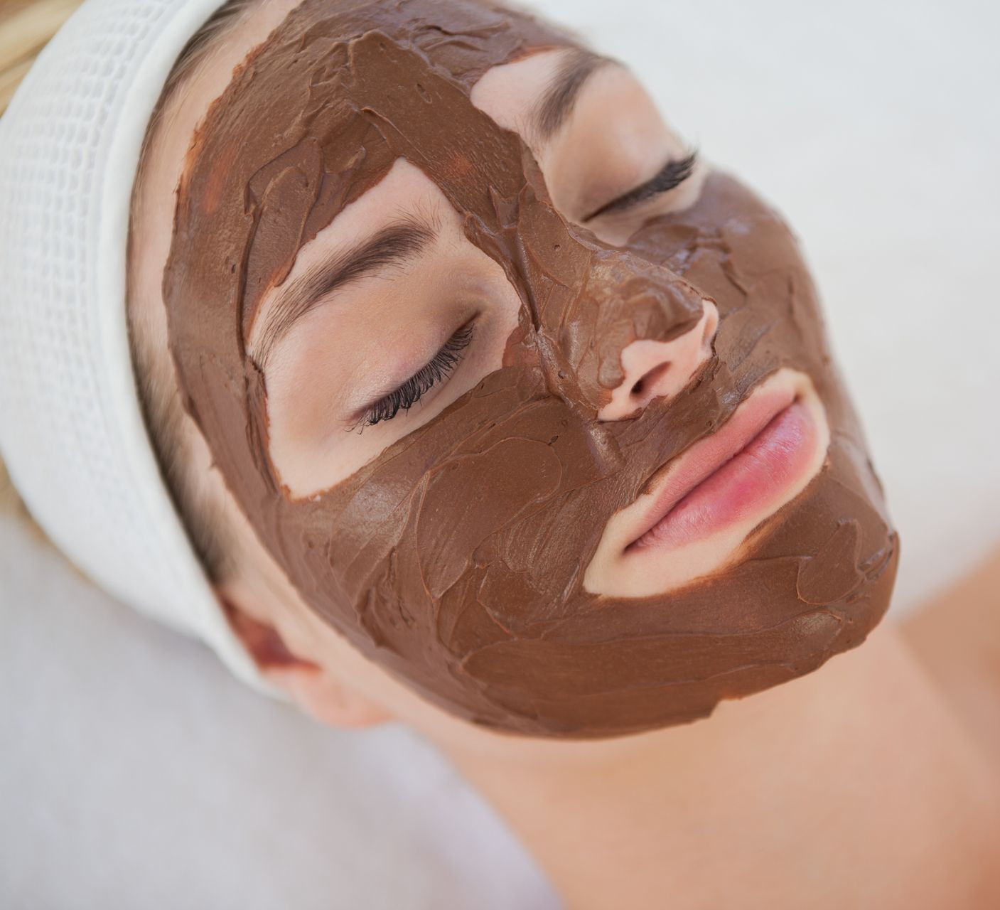 a woman with chocolate face mask on her face