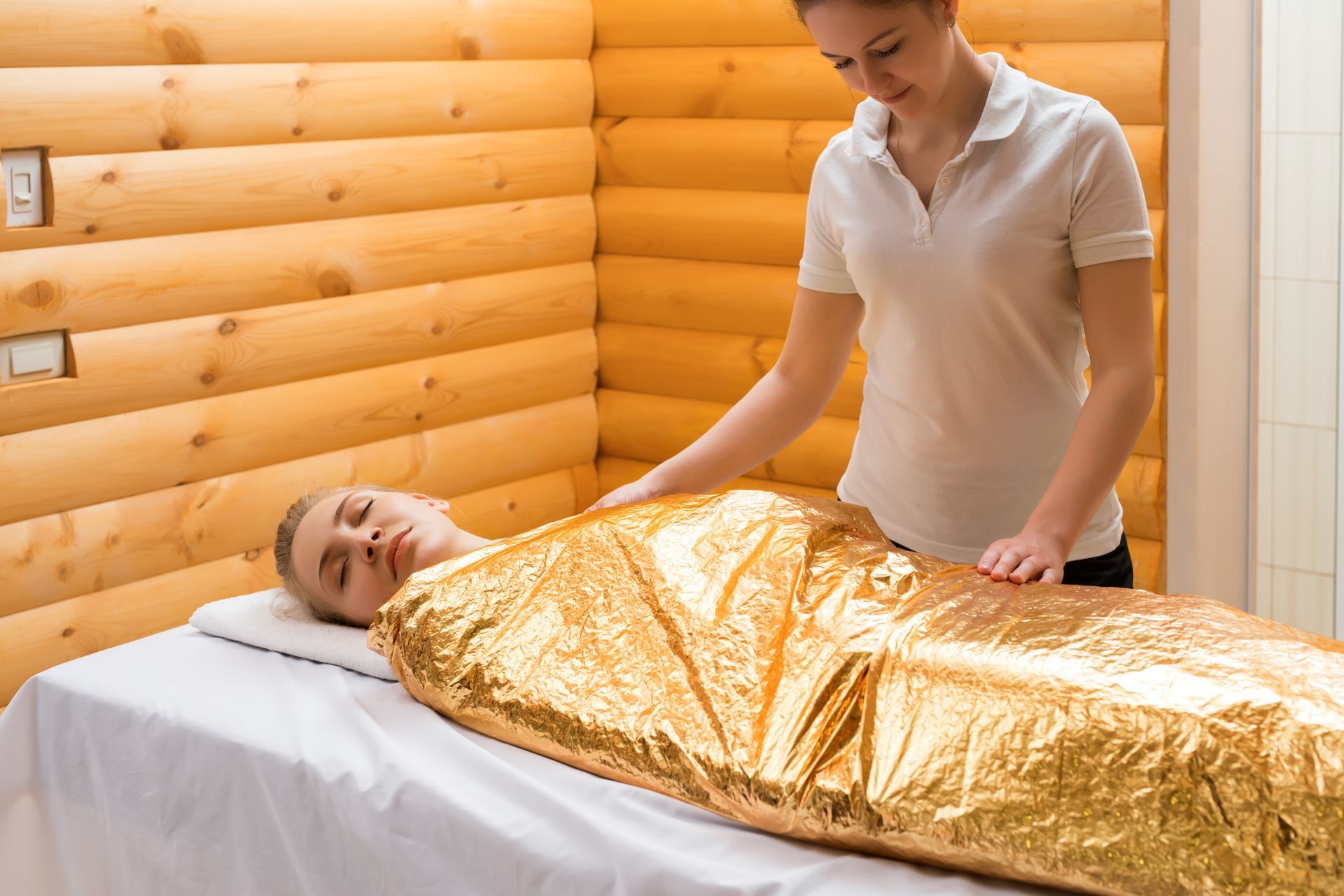 a woman in a hot body wrap in a sauna