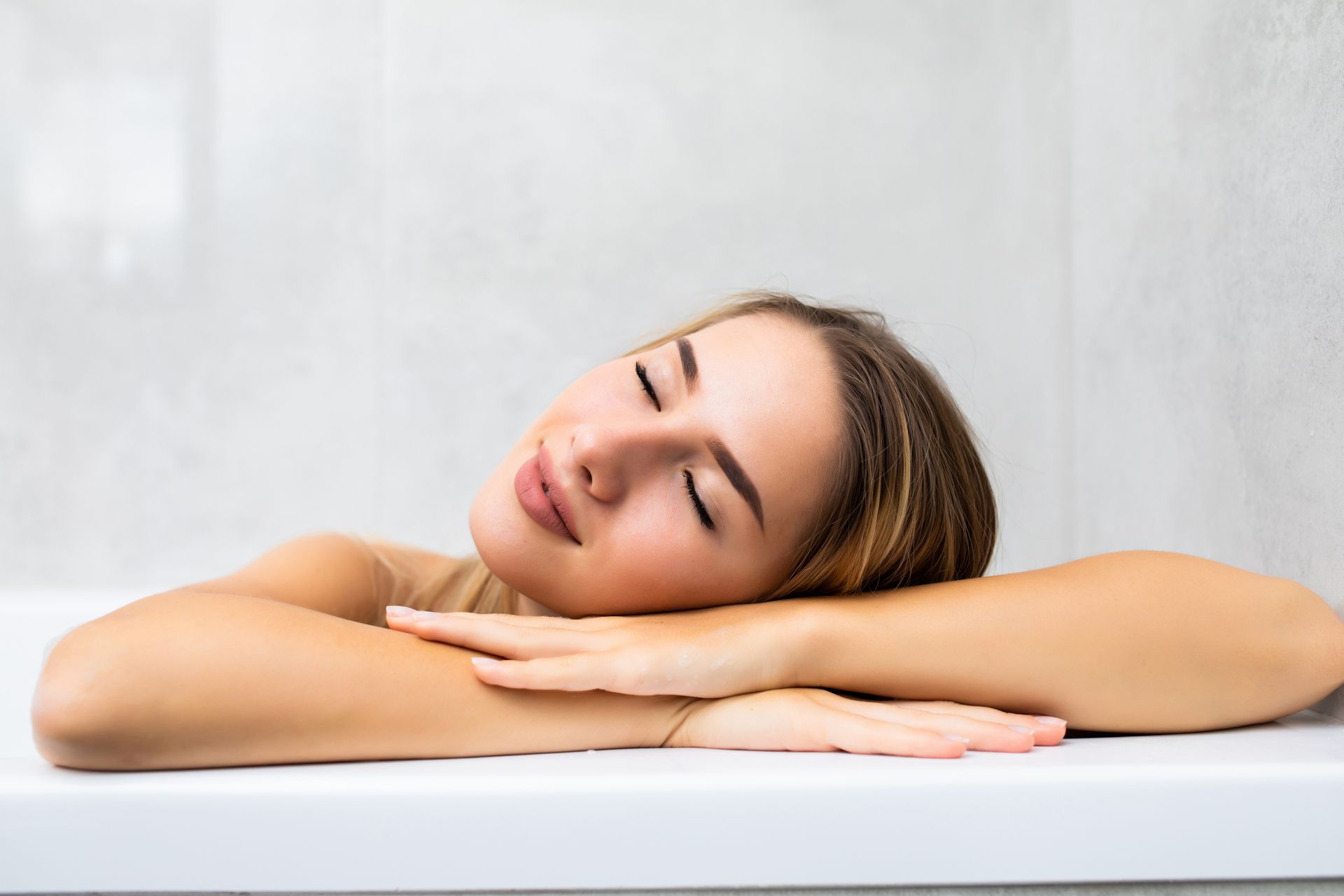 a relaxed-looking woman with her eyes closed