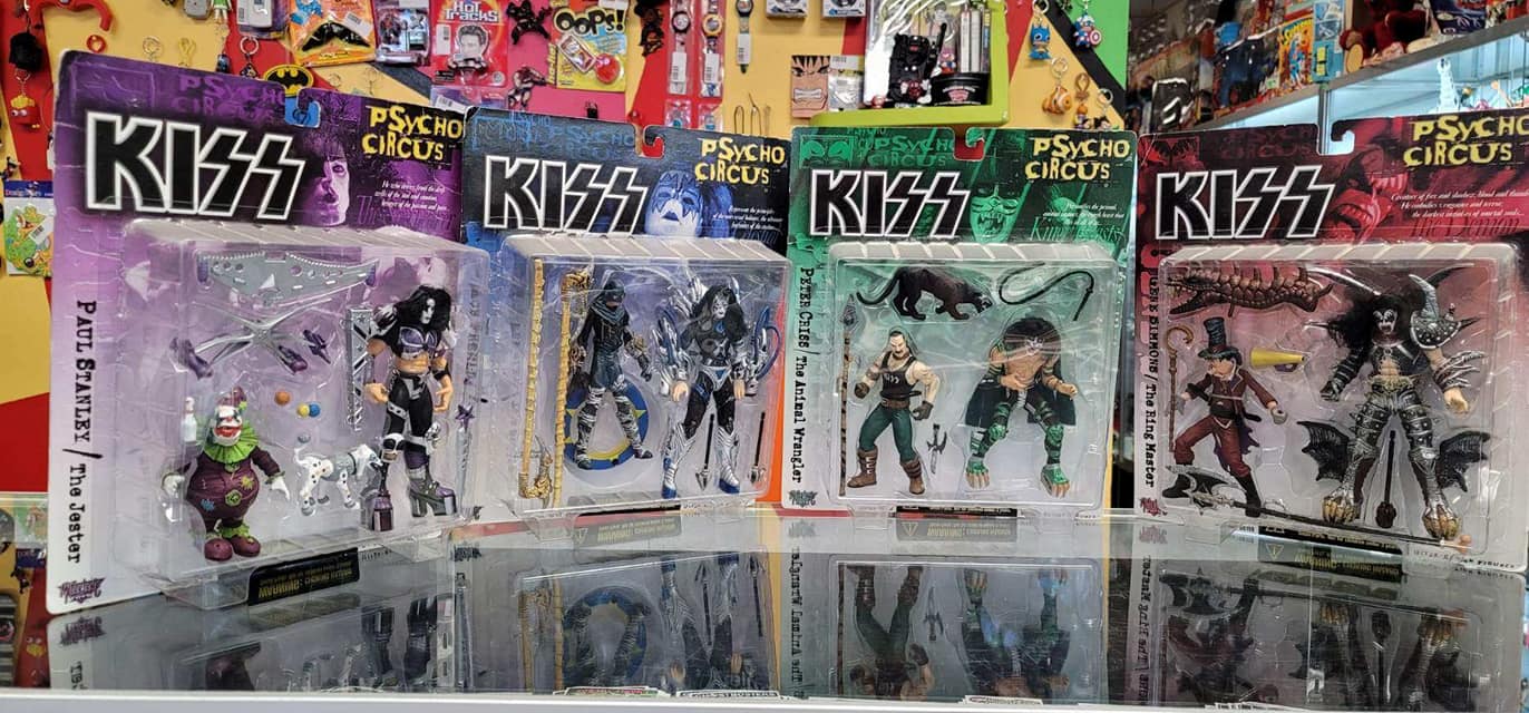 Four boxed KISS Psycho Circus action figures displayed in a store.