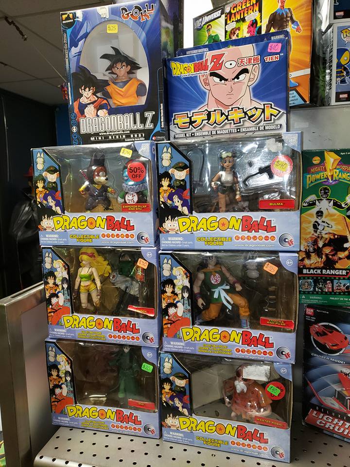 A shelf in a store filled with various Dragon Ball Z action figure boxes.