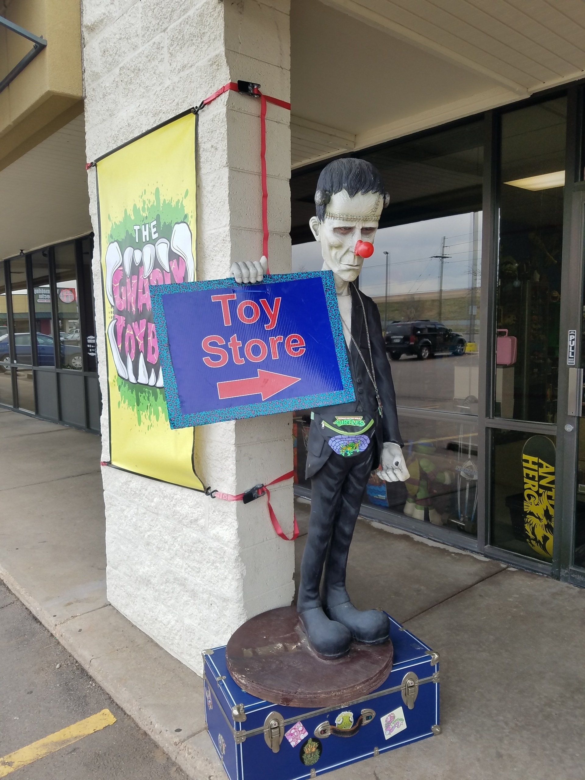 Gnarlyt Toybox Sign being help by Frankenstien out front of the store