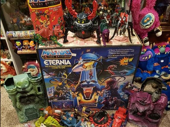 Eternia and other Masters of the Universe toys with a giggly eye monster hanging in the back!