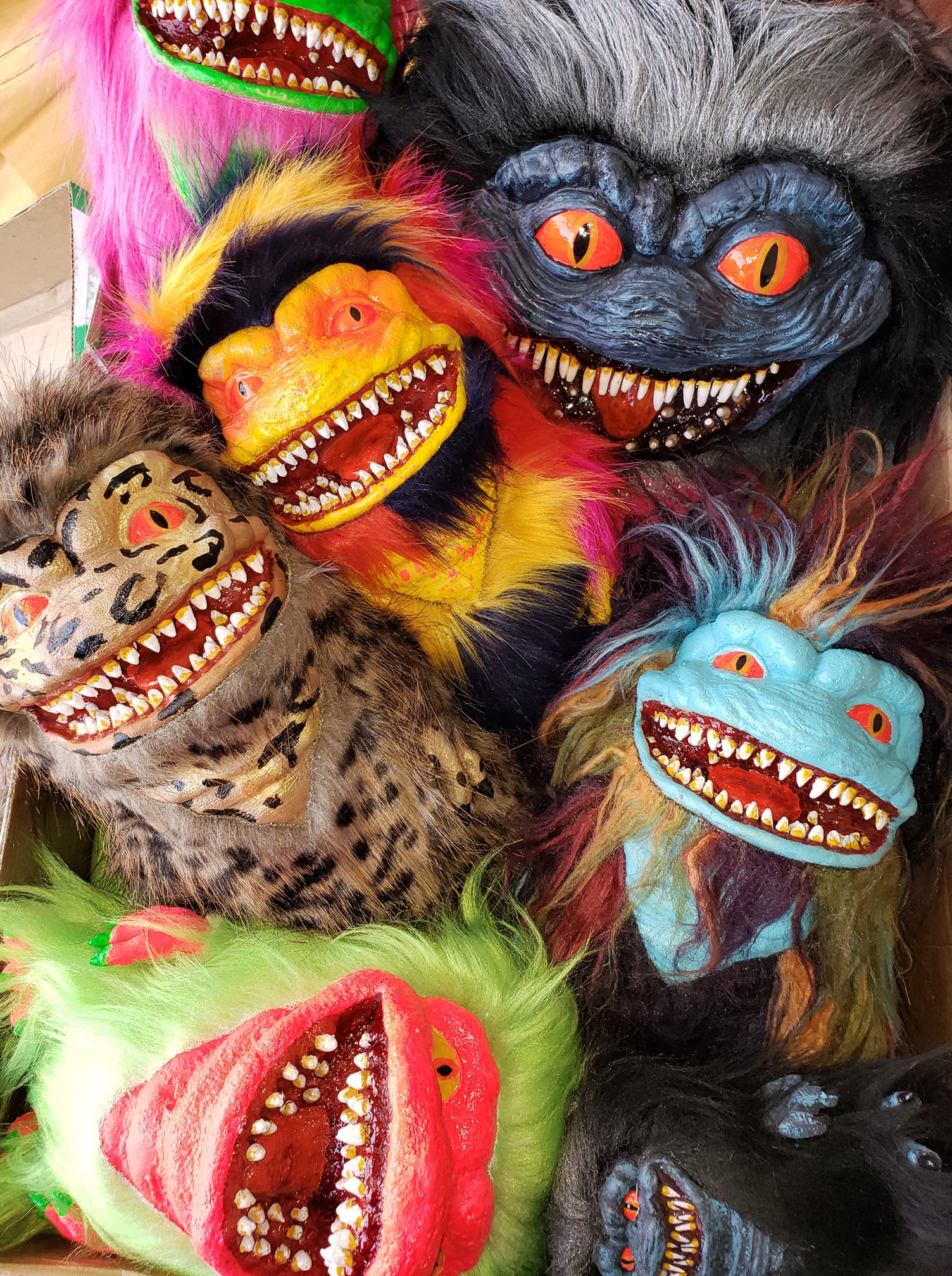 A cluster of colorful, furry Critter-style monster puppets with sharp teeth and expressive eyes crammed together.