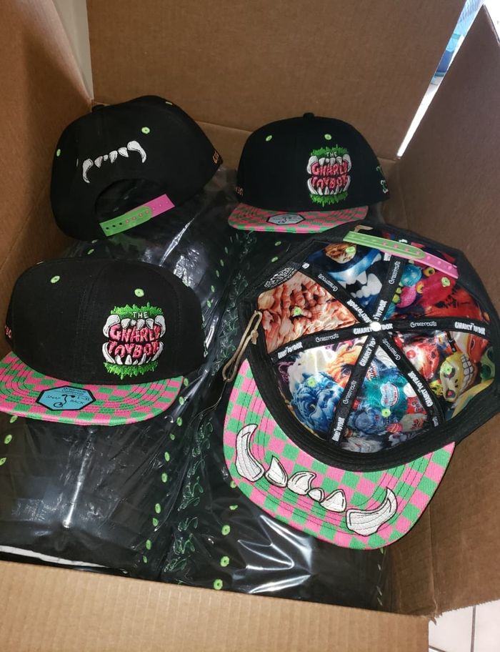 A cardboard box containing The Gnarly Toybox Grassroots Hats
