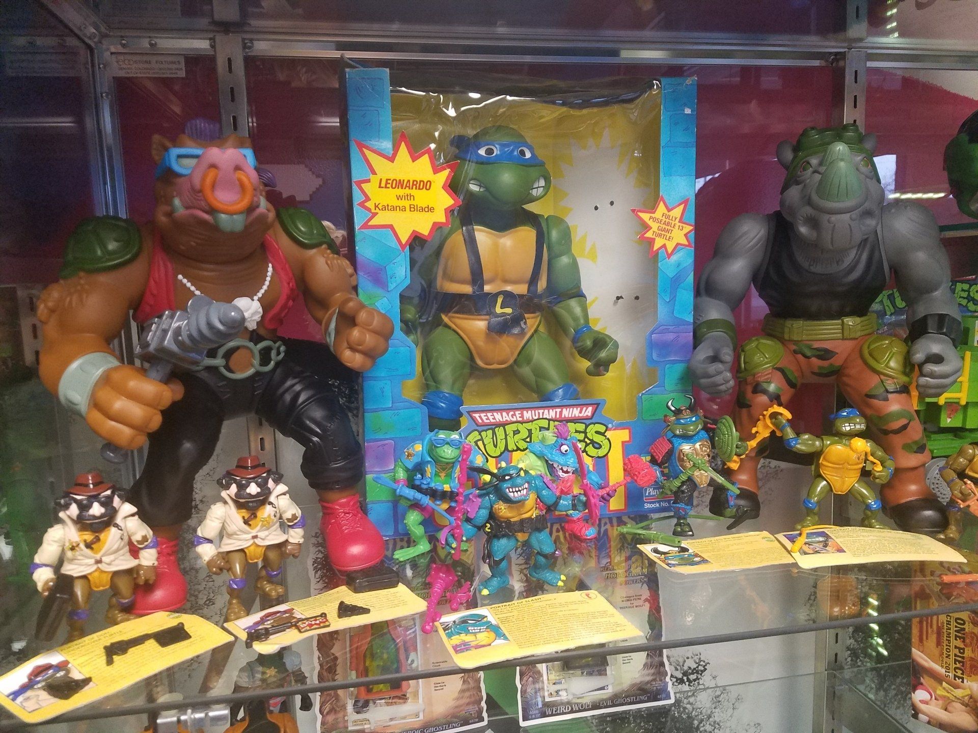 A display of vintage Teenage Mutant Ninja Turtles action figures, including Bebop, Rocksteady, and Leonardo, in a store.