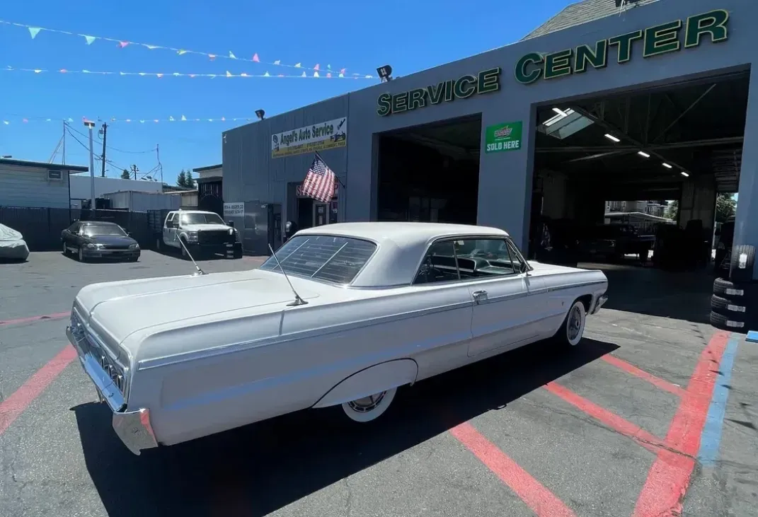 White car parked in front of garage in San Leandro, CA | Angel’s Automotive Center