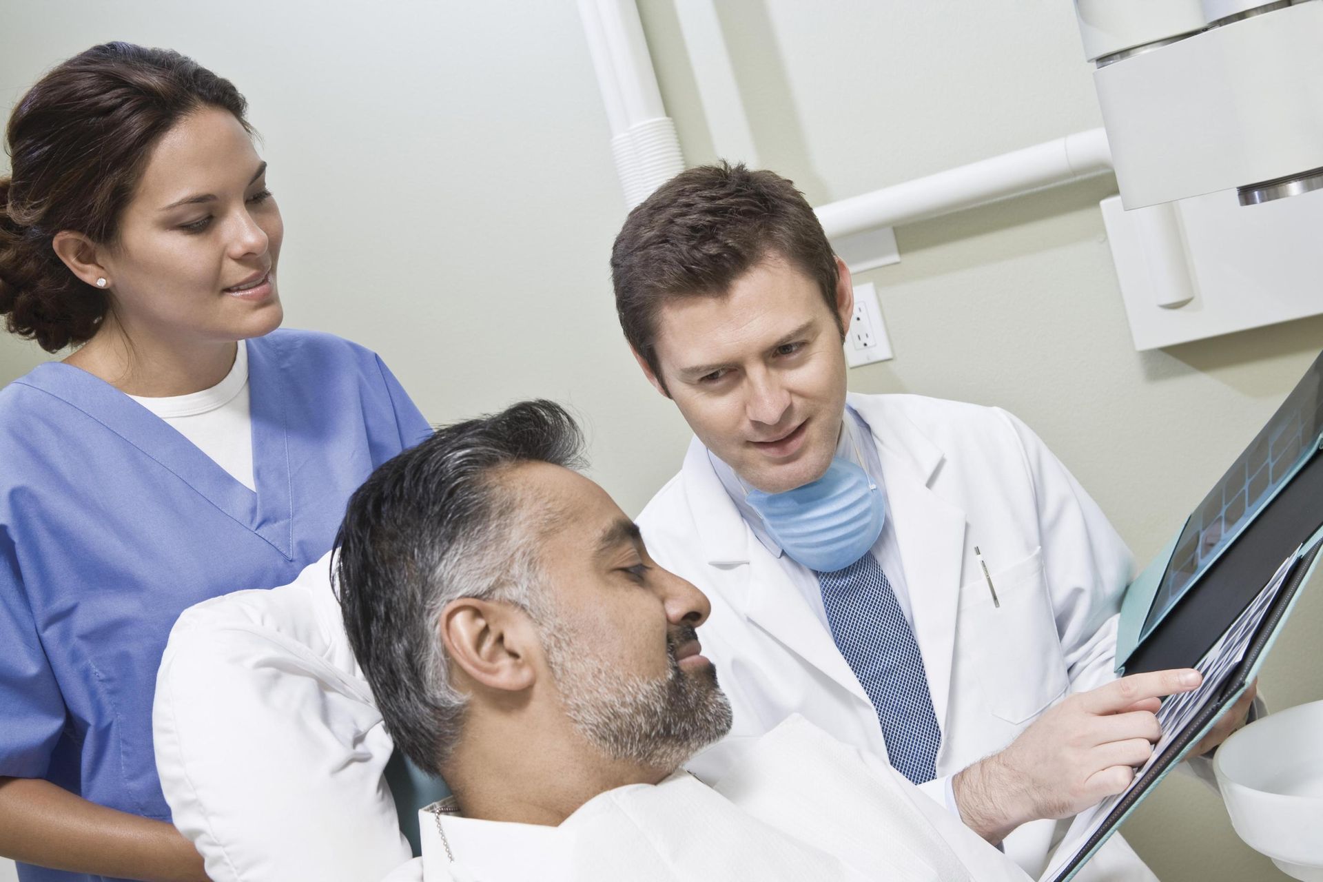 Dentist showing reports to patient.
