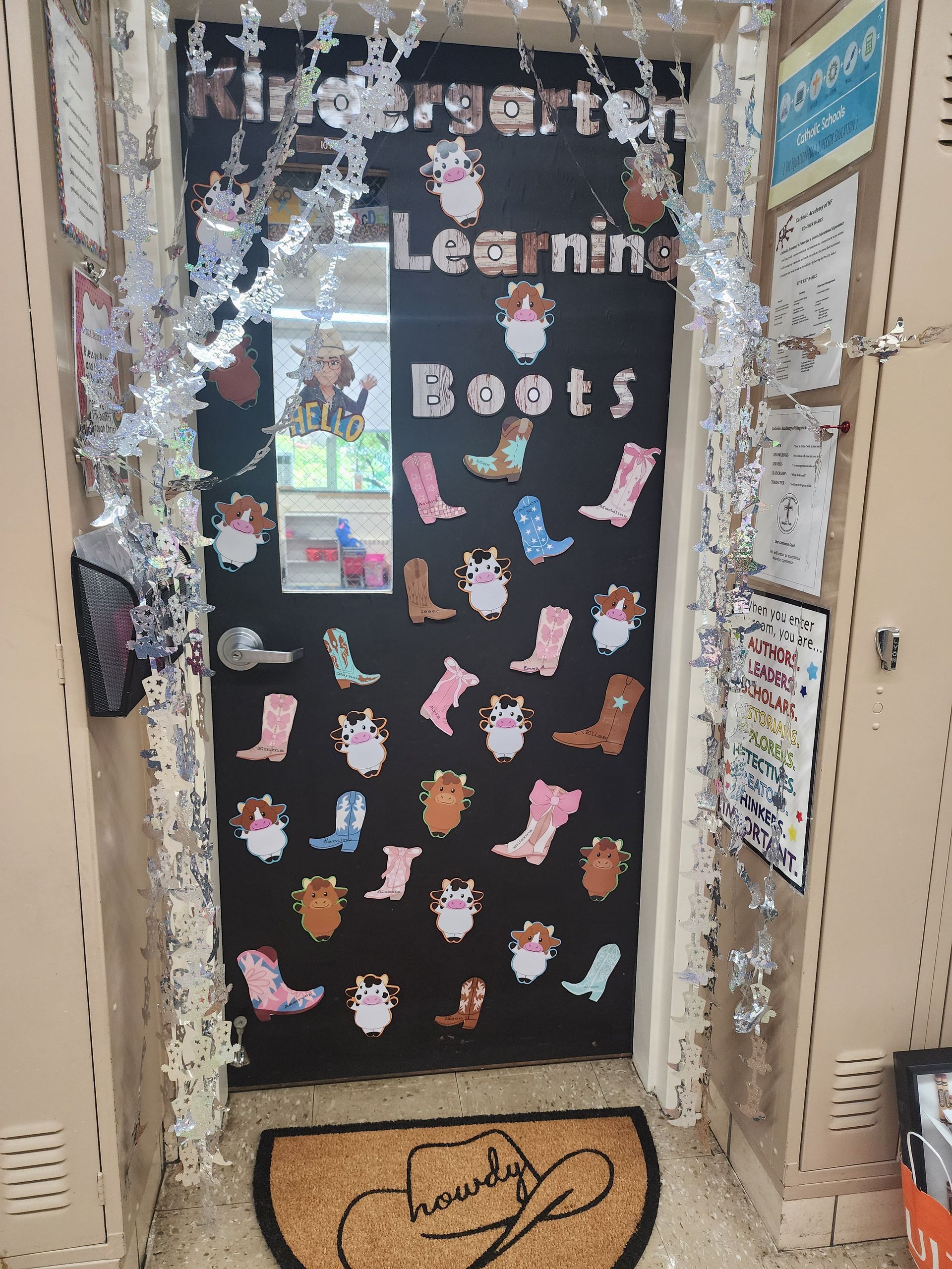 Kindergarten classroom door decorated with boot cutouts and silver tinsel, reads 