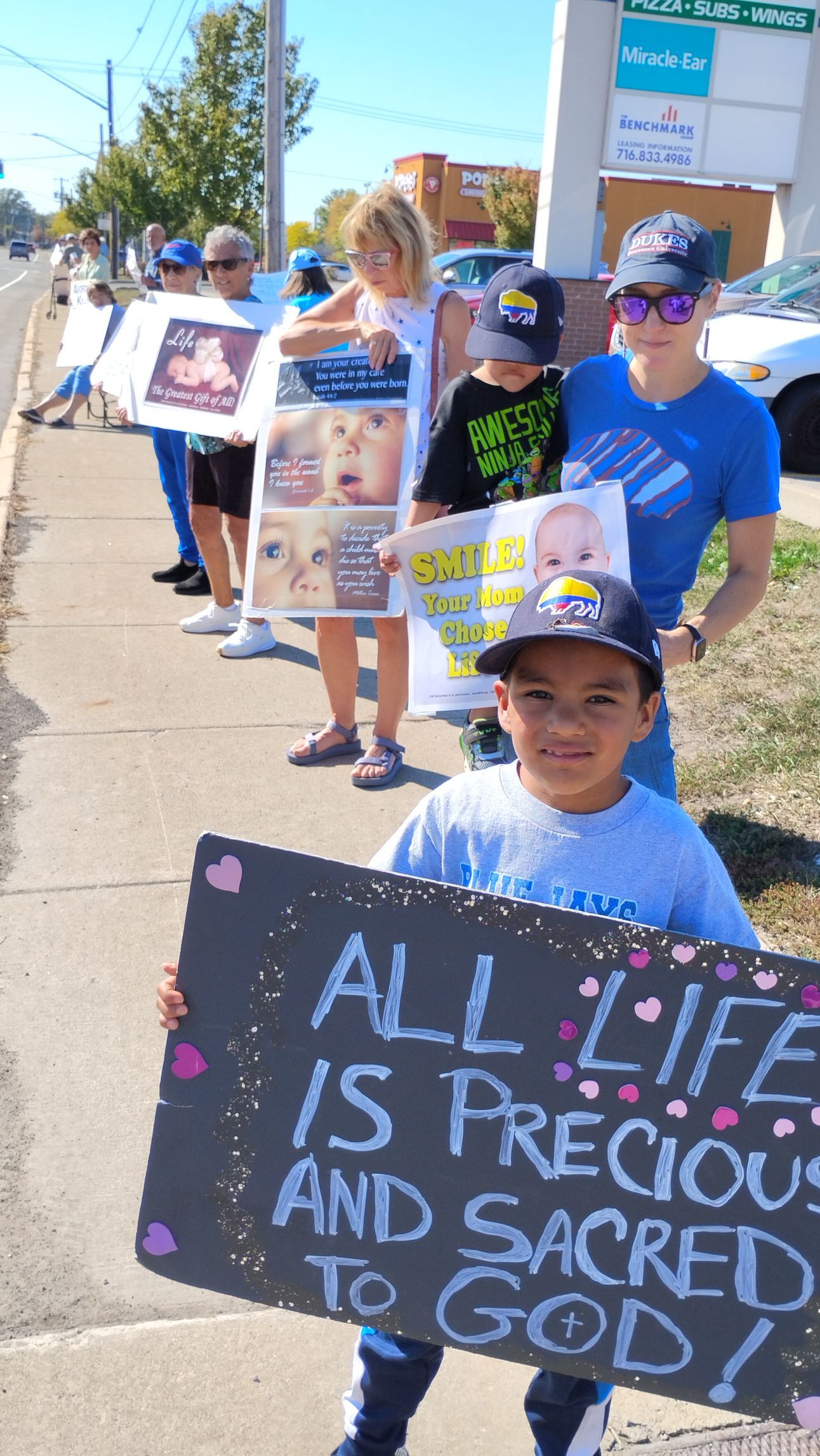 People holding signs that say 