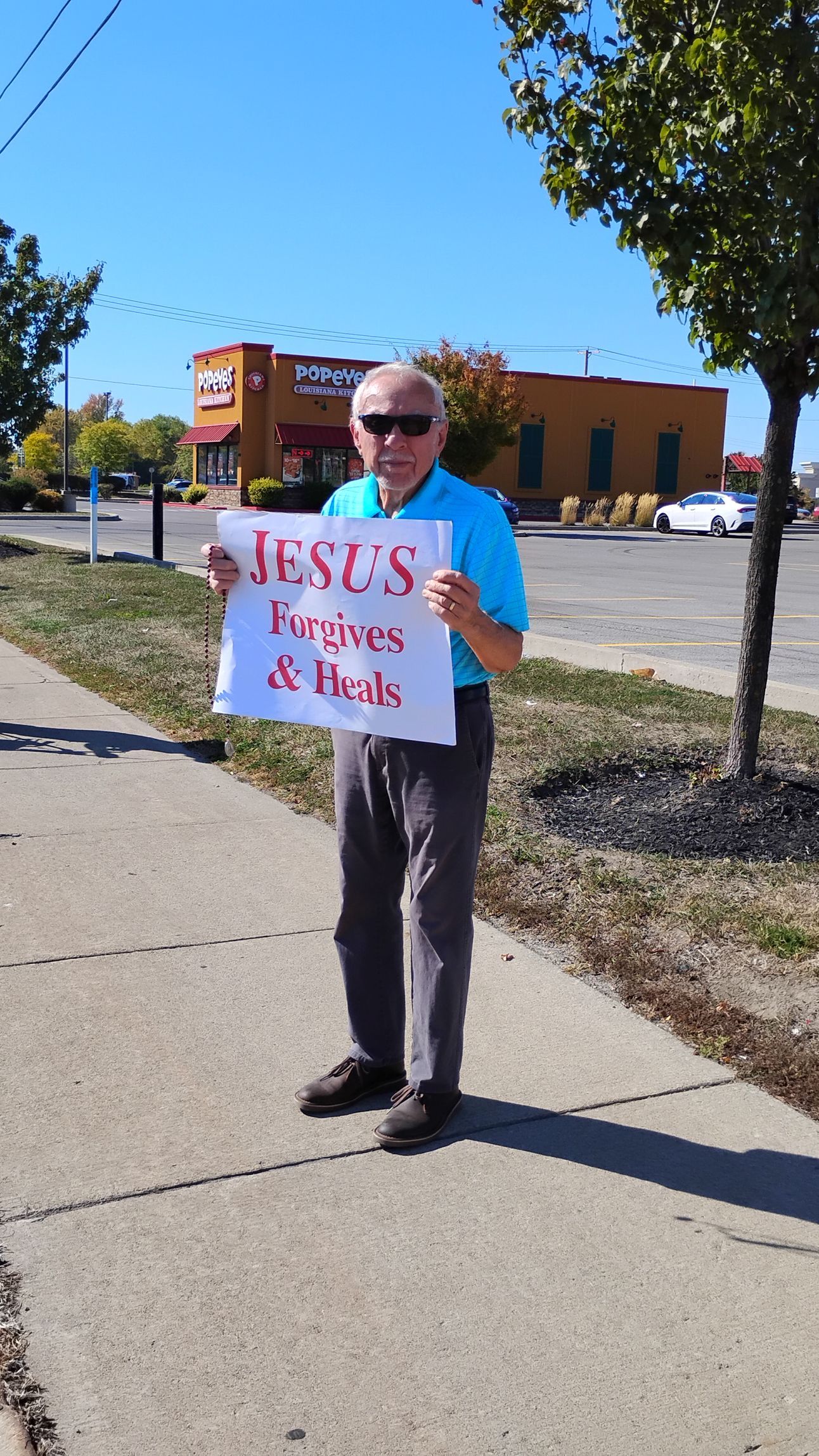 Man holding a sign that reads 
