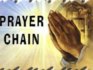 Praying hands in front of a bright light with 
