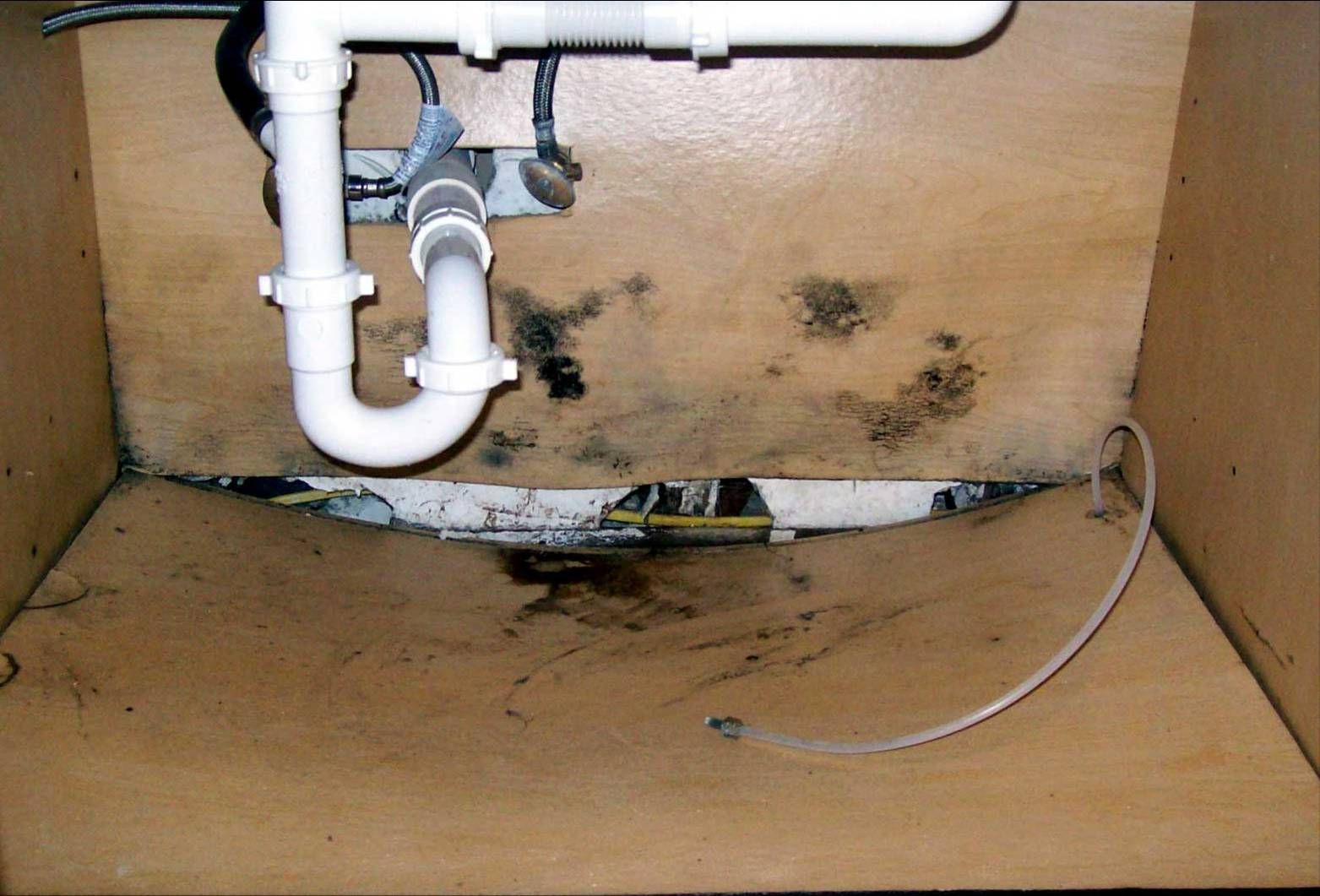 A sink with a white pipe underneath it