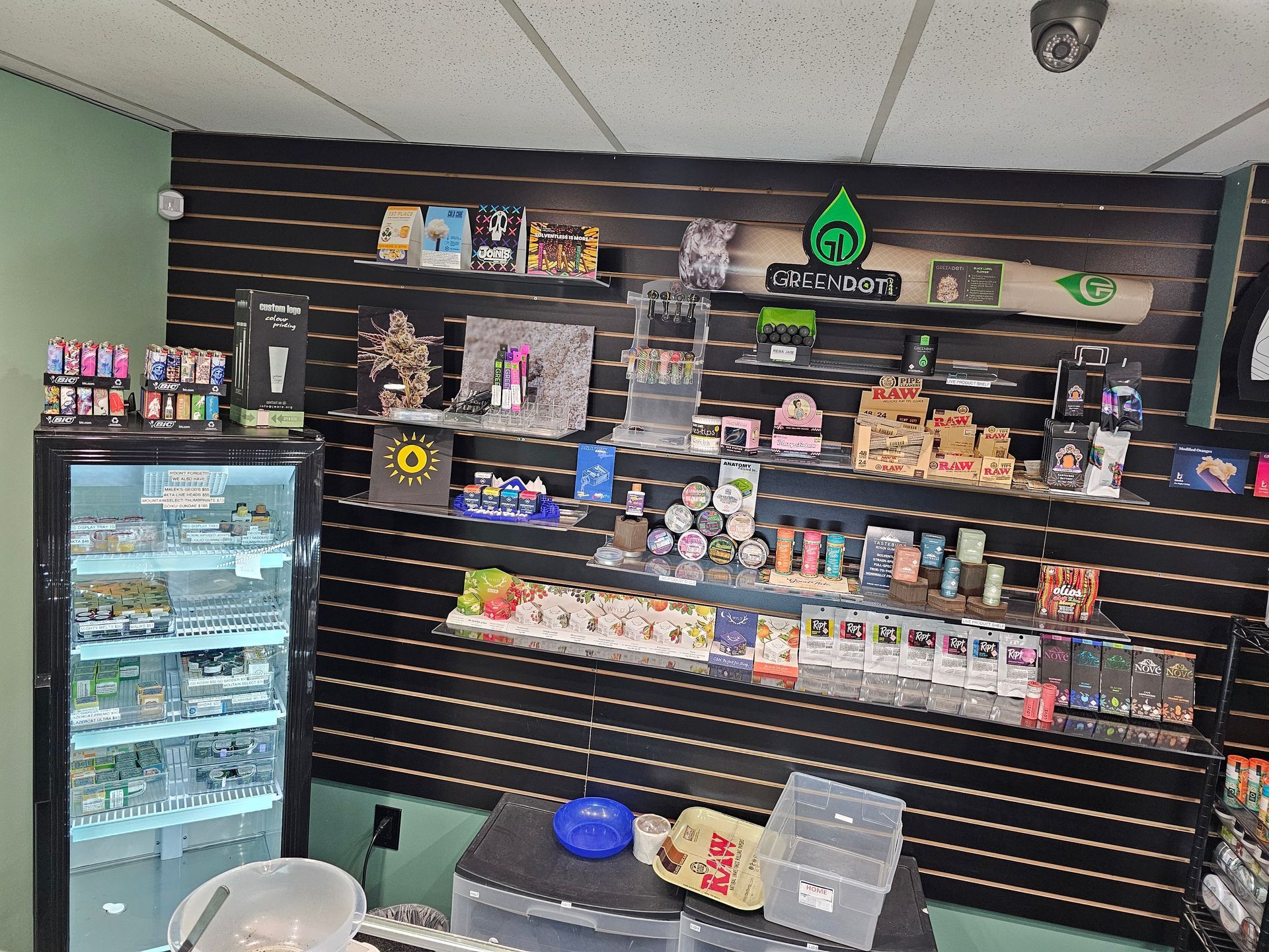 A store filled with lots of items on shelves and a refrigerator.