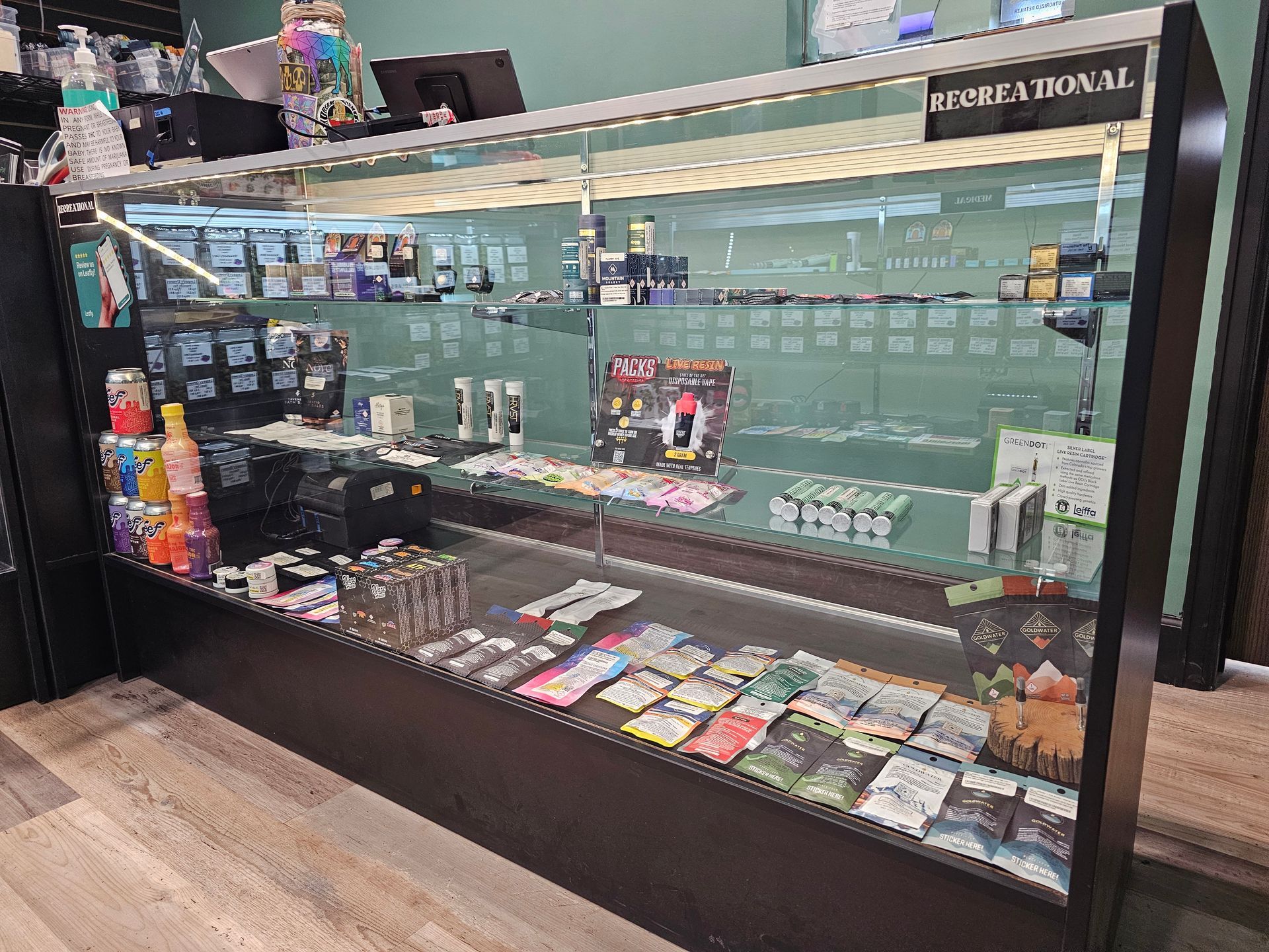 A glass display case filled with lots of items in a store.
