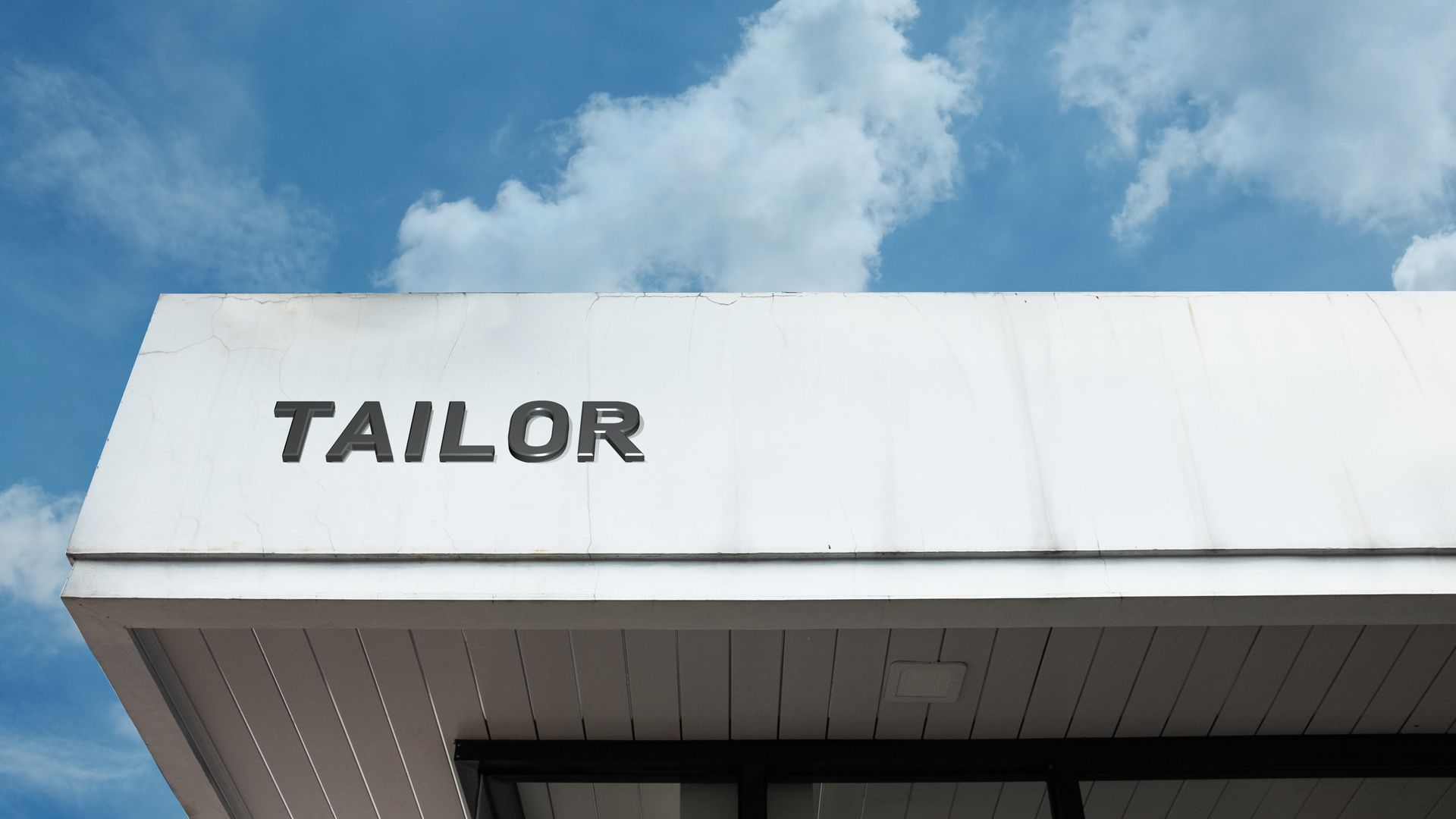 Tailor word signage on a commercial retail building. Tailor word signage on a commercial retail building.