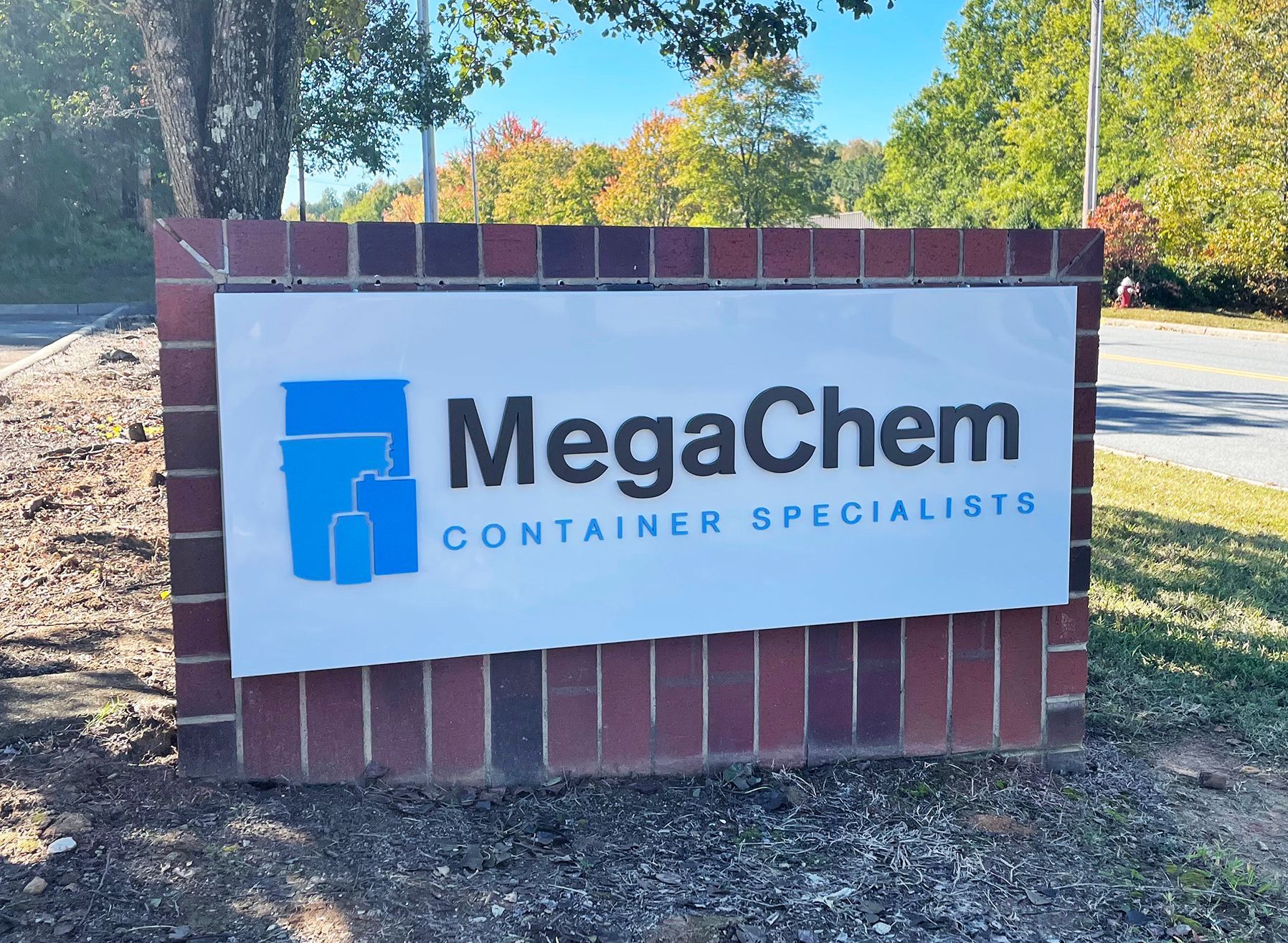 AMPAC Forwarding sign on a brick building against a blue sky