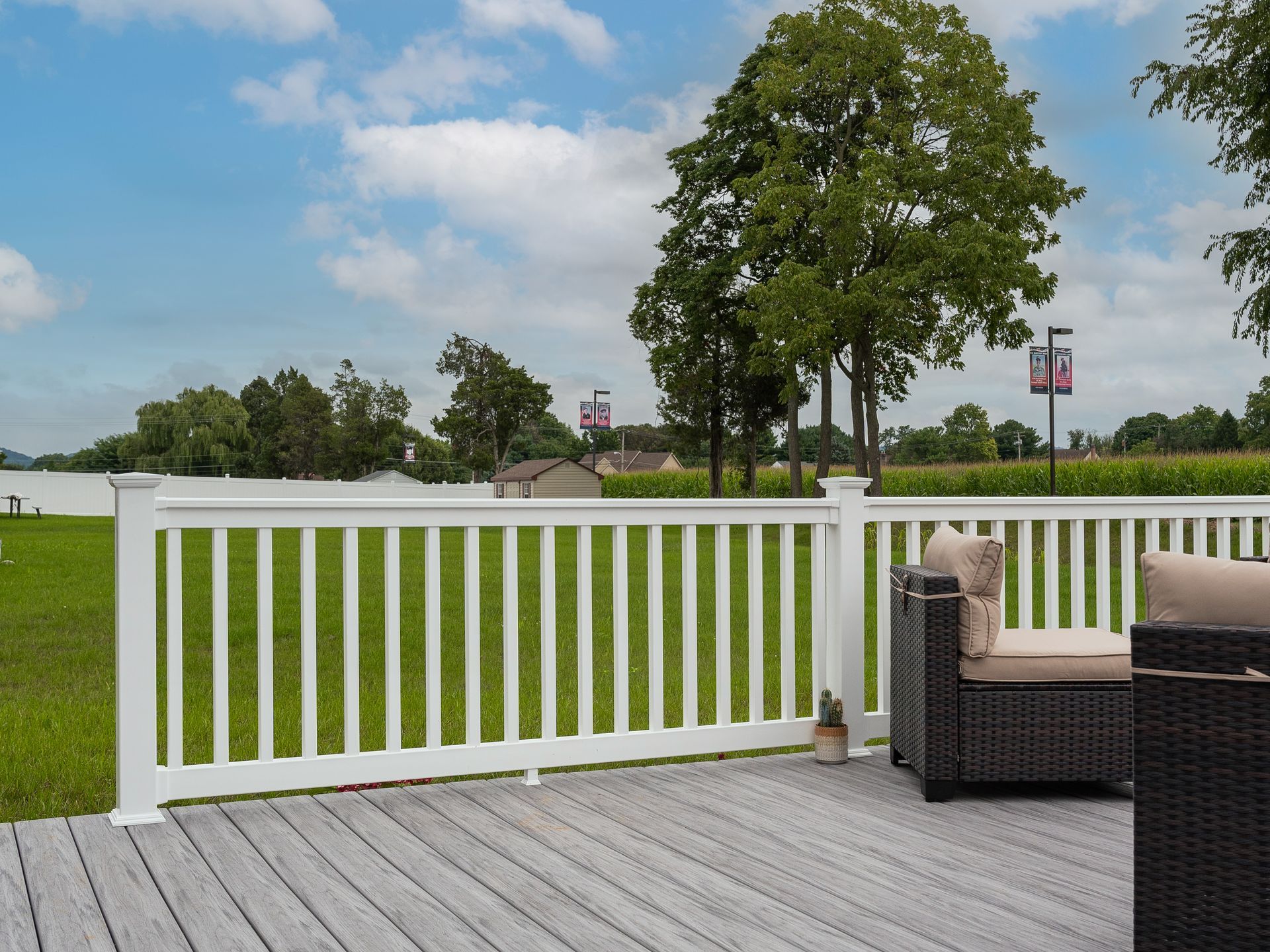 Deck with railing A deck with a white railing and a chair on it