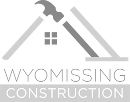 Wyomissing Construction A black and white logo for wyomissing construction with a hammer and saw.