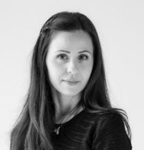 Une photo en noir et blanc d'une femme aux cheveux longs portant une chemise noire.