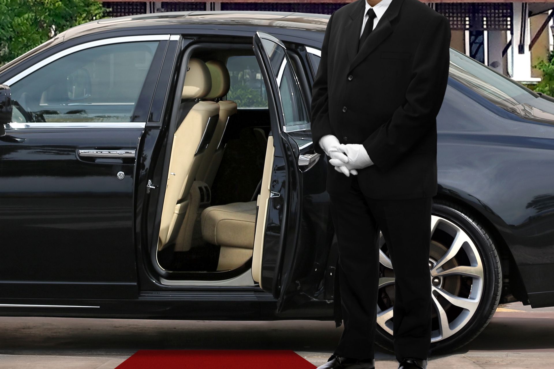 chauffeur waiting beside the car