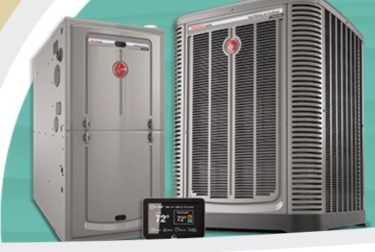 Two air conditioners are sitting next to each other on a green background.