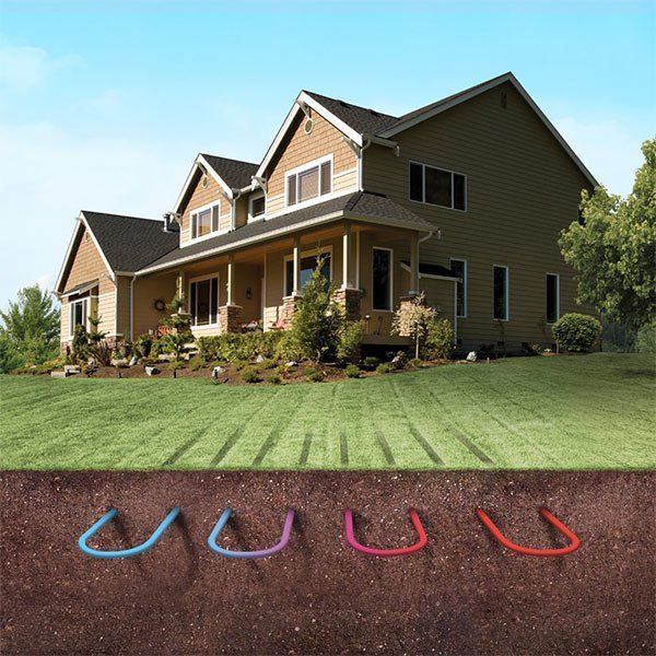 A house with a lawn and a bunch of pipes in the ground