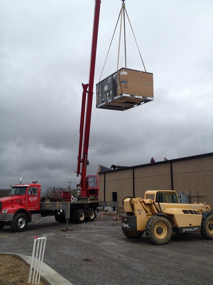 A large box is being lifted by a crane