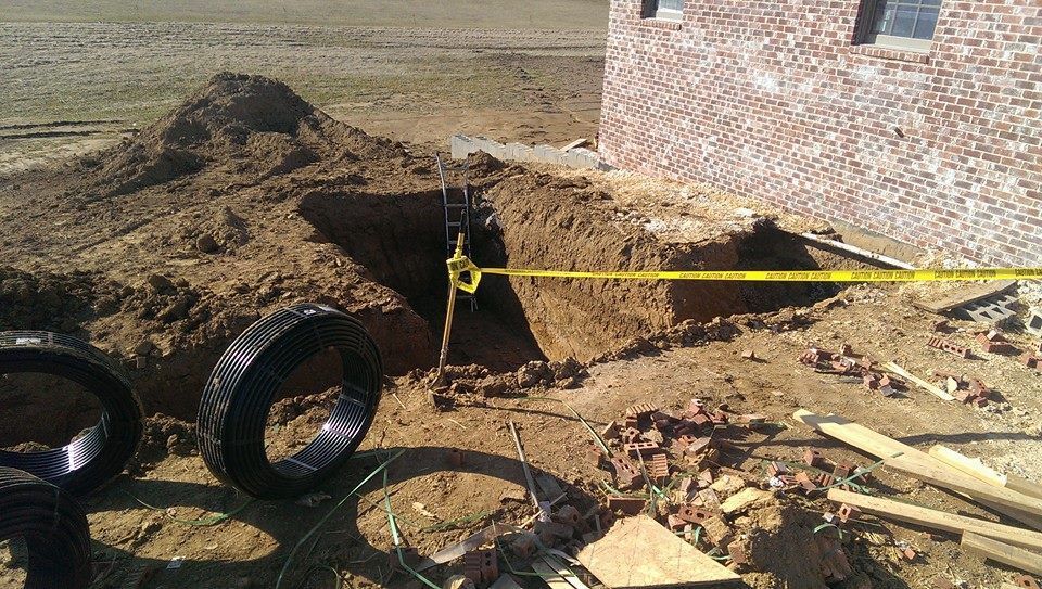 A hole in the ground with a yellow tape around it