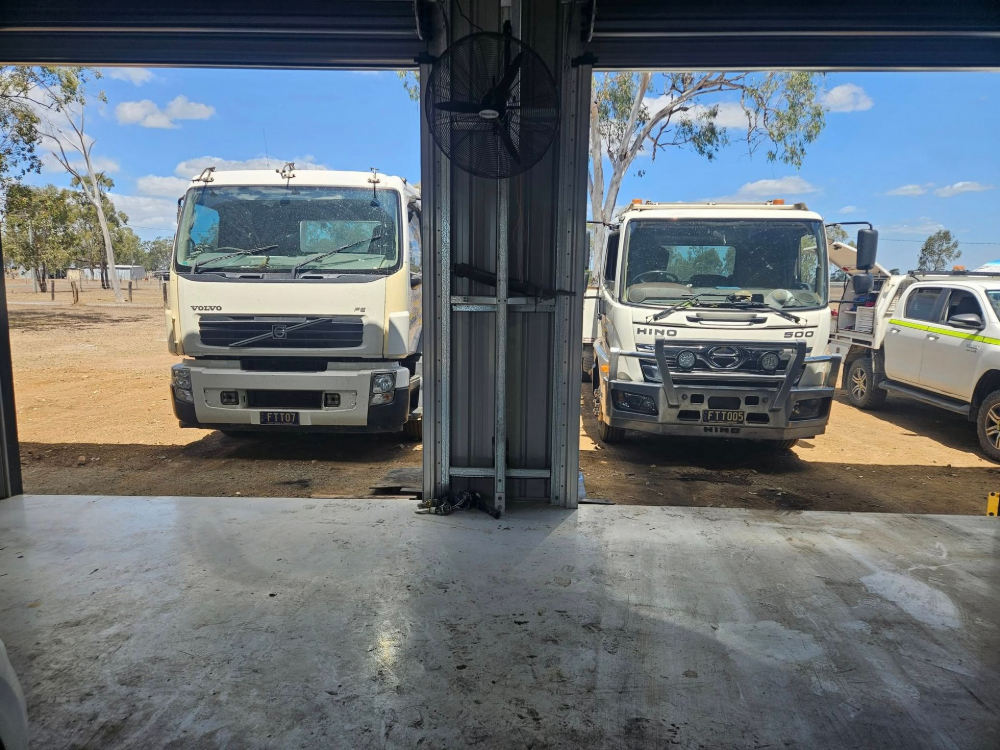 Two Trucks Parked in Front of a Garage Opening — Cap Coast Maintenance In Alton Downs, QLD