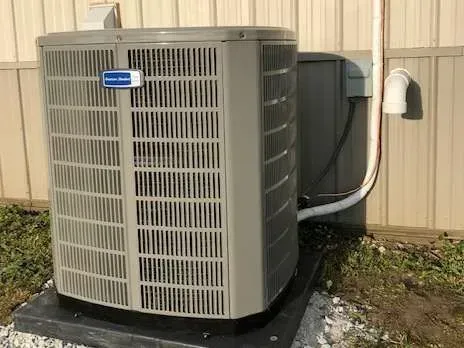 An American Standard air conditioning unit outside a building.