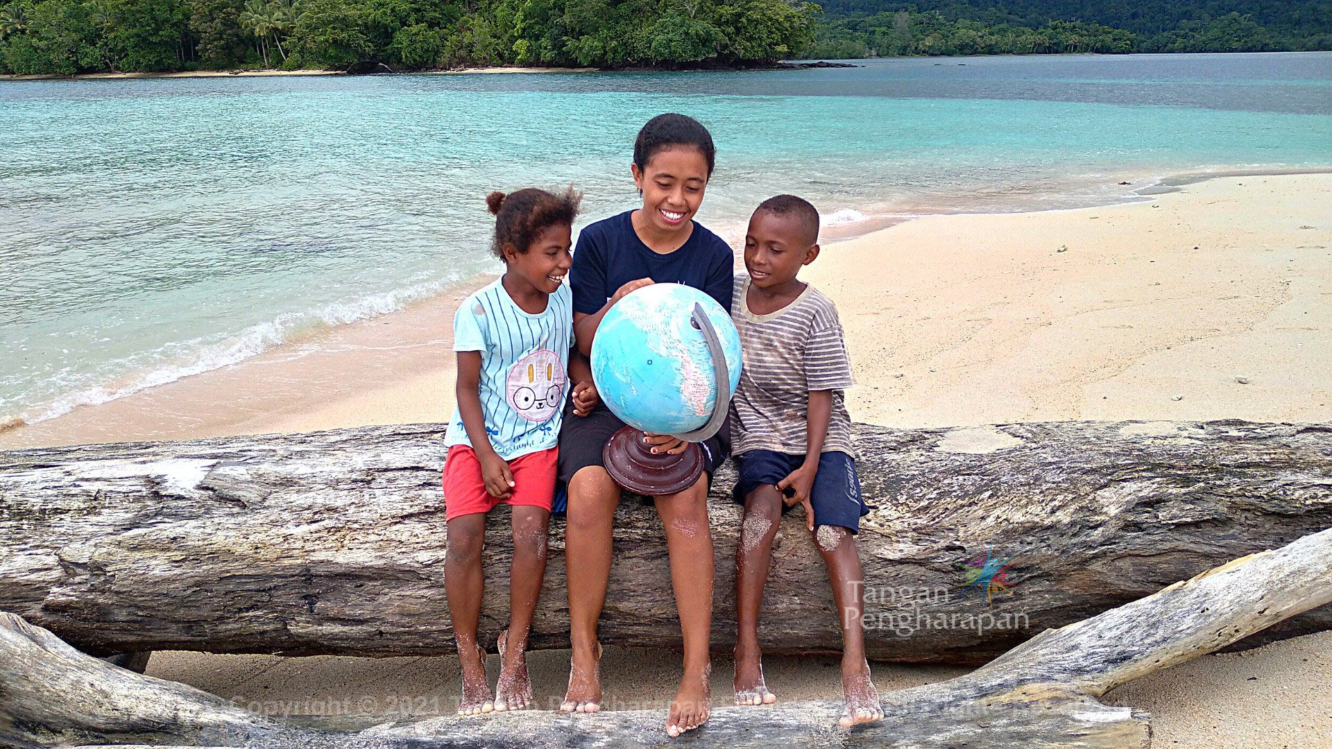 A Girl Showing a Globe to Children — Safety Boots in Jakarta Indonesia