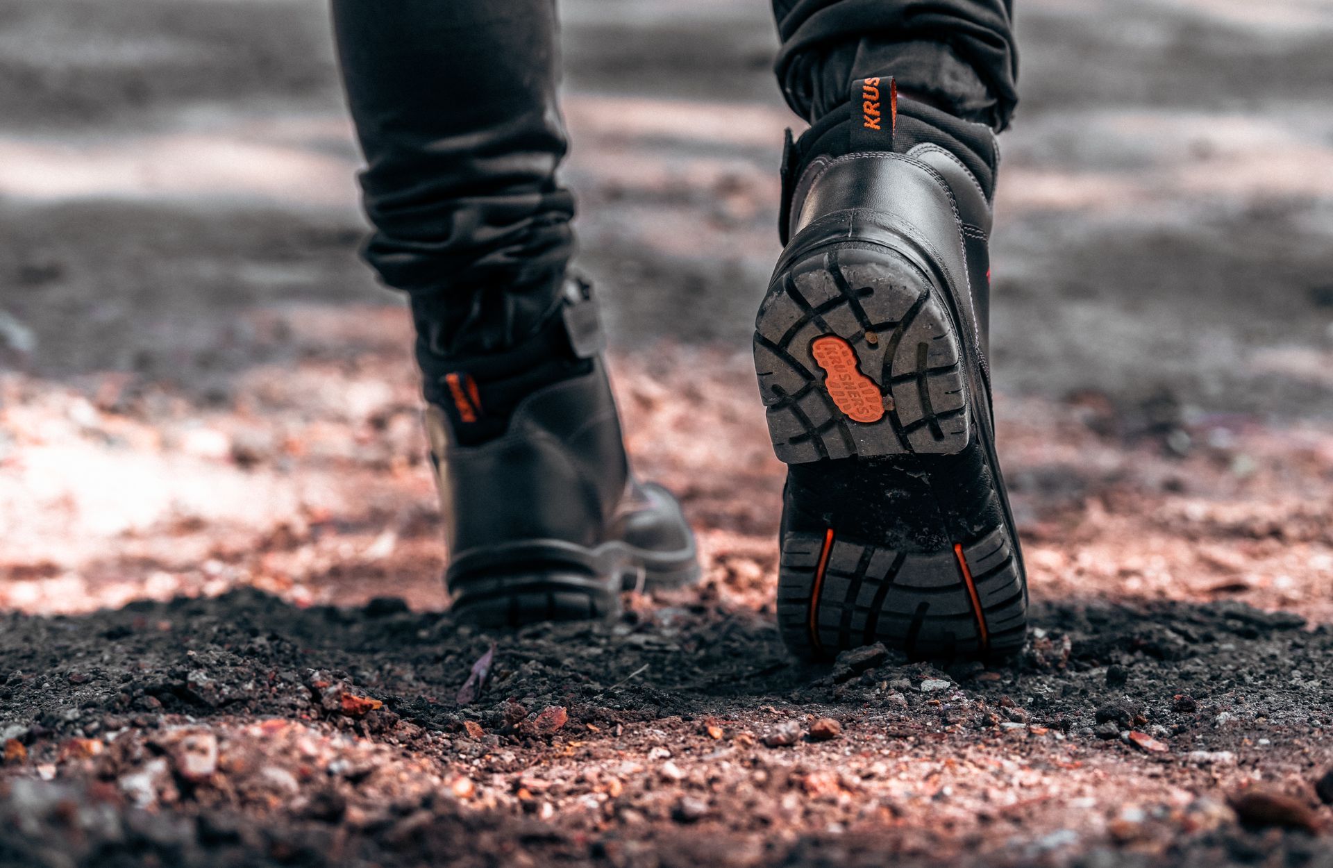 a person wearing a pair of KRUSHERS safety boots showing the tough durable sole 