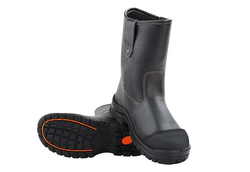 A pair of black boots with orange soles on a white background.
