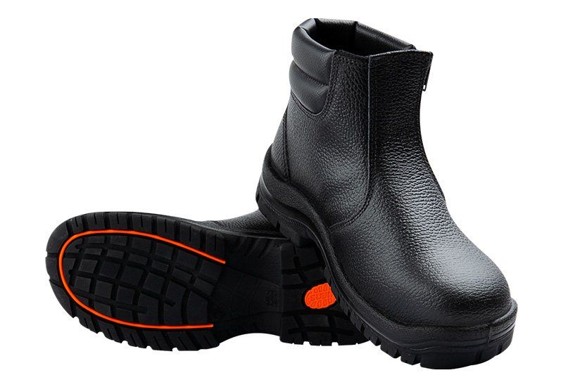 A pair of black boots with an orange sole on a white background